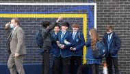 Year 9 students react as they speak with Principal, James Fisher, on the first day back at school, as the coronavirus disease (COVID-19) lockdown begins to ease at Harris Academy Sutton, south London, Britain, March 8, 2021. REUTERS/Toby Melville