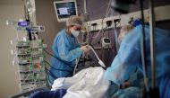 Medical staff members work in the Intensive Care Unit (ICU) where patients suffering from the coronavirus disease (COVID-19) are treated at the Melun-Senart hospital, near Paris, France, March 8, 2021. REUTERS/Benoit Tessier

