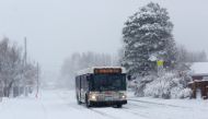A city bus makes its way through snowy streets during a storm in DENVER, Colorado, U.S., March 14, 2021. REUTERS/Kevin Mohatt
