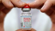 Walmart pharmacist holds a vial of the Moderna coronavirus disease (COVID-19) vaccine inside a Walmart department store as Walmart and other major U.S. pharmacies take part in the Federal Retail Pharmacy Program, to increase vaccinations in the U.S. in We