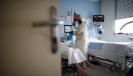 A medical staff member works in the Intensive Care Unit (ICU) where patients suffering from the coronavirus disease (COVID-19) are treated at the Clinique de l'Estree - ELSAN private hospital in Stains, near Paris, France, March 18, 2021. REUTERS/Benoit T