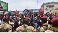 Soldiers from the Republic Guard hold incumbent President Denis Sassou Nguesso's supporters back as they cheer him while he drives away from a polling station in Brazzaville, Republic of Congo, March 21, 2021. REUTERS/Olivia Acland