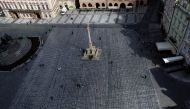People are seen at the Old Town Square where thousands of crosses have been painted on a pavement to commemorate the first anniversary since the death of the first Czech coronavirus disease (COVID-19) patient in Prague, Czech Republic, March 22, 2021. REU