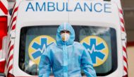 A medical worker wearing protective gear stands next to an ambulance outside a hospital for patients infected with the coronavirus disease (COVID-19) in Kyiv, Ukraine November 24, 2020. REUTERS/Gleb Garanich/File Photo/File Photo