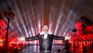French DJ David Guetta poses in front of the Louvre Pyramid before performing the 'United at Home' fundraising live concert for New Year's Eve, in Paris, France, December 29, 2020. REUTERS/Charles Platiau/File Photo
