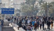 People enjoy a sunny and warm weather on the Promenade des Anglais during the third lockdown imposed to slow the rate of the coronavirus disease (COVID-19) contagion, in Nice, France, March 27, 2021. Reuters/ Eric Gaillard