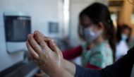 Schoolchildren clean their hands at the private primary school Jeanne D'Arc in Saint-Maur-des-Fosses, near Paris, amid the coronavirus disease (COVID-19) outbreak in France, March 30, 2021. Reuters/Gonzalo Fuentes