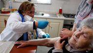 Doctor Pina Tomaselli prepares to administer the Moderna coronavirus disease (COVID-19) vaccine at a care home in Naples, Italy, March 30, 2021. REUTERS/Ciro De Luca
