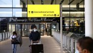 FILE PHOTO: Travellers walk through Terminal 2 at Heathrow Airport, amid the coronavirus disease (COVID-19) outbreak in London, Britain February 14, 2021. REUTERS/Henry Nicholls//File Photo
