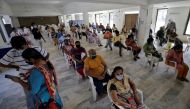 People sit in a waiting area to receive a dose of COVISHIELD, a coronavirus disease (COVID-19) vaccine manufactured by Serum Institute of India, at a vaccination centre in Ahmedabad, India, April 2, 2021. REUTERS/Amit Dave