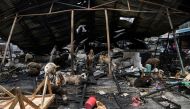 Animals are pictured at the burned stall after the fire in the traditional market in Jakarta, Indonesia April 10, 2021, in this photo taken by Antara Foto/Sigid Kurniawa/via Reuters.