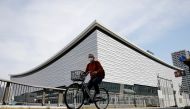 File photo: A man wearing a protective mask amid the coronavirus disease (COVID-19) outbreak cycles past Ariake Arena in Tokyo, Japan, April 8, 2021. Reuters/Kim Kyung-Hoon/File Photo