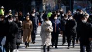 Commuters cross a zebra crossing, amid the coronavirus disease (COVID-19) pandemic in Seoul, South Korea, February 3, 2021. REUTERS/Kim Hong-Ji
