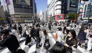 Passersby wearing protective face masks walk on Shibuya crossing amid the coronavirus disease (COVID-19) outbreak in Tokyo, Japan April 23, 2021, in this photo taken by Kyodo. Kyodo/via REUTERS