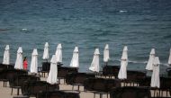 A tourist walks near empty sunbeds at Sunny Beach resort on the Black Sea, Bulgaria June 23, 2020. Picture taken June 23, 2020. REUTERS/Stoyan Nenov/File Photo
