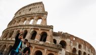 People take a selfie outside the Colosseum on the day of its reopening, as much of the country becomes a 'yellow zone', easing coronavirus disease (COVID-19) restrictions, in Rome, Italy, April 26, 2021. Reuters/Guglielmo Mangiapane