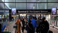People queue to enter terminal 2, as tighter rules for international travellers start, at Heathrow Airport, amid the spread of the coronavirus disease (COVID-19) pandemic, London, Britain, January 18, 2021. REUTERS/Henry Nicholls/File Photo