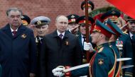Russian President Vladimir Putin and Tajik President Emomali Rakhmon watch honour guards passing by during a commemoration ceremony at the Tomb of the Unknown Soldier on Victory Day, which marks the 76th anniversary of the victory over Nazi Germany in Wor