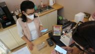 Candy store owner Jitka Hornakova receives Corrency (covid currency) payment through a mobile application, amid the coronavirus disease (COVID-19) pandemic, in Kyjov, Czech Republic, May 12, 2021. Picture taken May 12, 2021. REUTERS/Jiri Skacel
