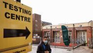 A man wearing a protective mask walks past a testing centre amid the outbreak of coronavirus disease in the Shoreditch area of London, Britain, May 17, 2021. Reuters/John Sibley