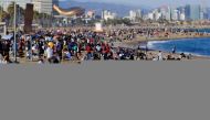 :FILE PHOTO: People spend time at Barceloneta beach, amid the coronavirus disease (COVID-19) outbreak, in Barcelona, Spain April 2, 2021. REUTERS/Nacho Doce/File Photo
