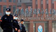 FILE PHOTO: Security personnel keep watch outside the Wuhan Institute of Virology during the visit by the World Health Organization (WHO) team tasked with investigating the origins of the coronavirus disease (COVID-19), in Wuhan, Hubei province, China Feb