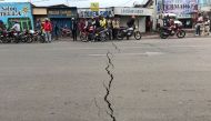 Congolese riders are seen near a crack on the road caused by earth tremors as aftershocks following the eruption of Mount Nyiragongo volcano near Goma, in the Democratic Republic of Congo May 26, 2021. Reuters/Djaffar Al Katanty