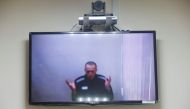 Russian opposition leader Alexei Navalny is seen on a screen via a video link during a hearing to consider his lawsuits against the penal colony over detention conditions there, at the Petushki district court in Petushki, Russia May 26, 2021. REUTERS/Maxi
