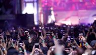 FILE PHOTO: Concertgoers use their mobile phones during Eminem's performance at the Coachella Valley Music and Arts Festival in Indio, California, U.S., April 15, 2018. REUTERS/Mario Anzuoni/File Photo
