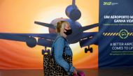 FILE PHOTO: A woman arrives at Faro Airport on the first day that Britons are allowed to enter Portugal without needing to quarantine, as coronavirus disease (COVID-19) restrictions are eased, in Faro, Portugal, May 17, 2021. REUTERS/Pedro Nunes/File Phot