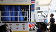 A medical worker gestures inside a coronavirus disease (COVID-19) vaccination truck in Kuala Lumpur, Malaysia June 8, 2021. REUTERS/Lim Huey Teng
