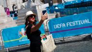 A woman is seen taking a selfie in a fan zone at Piazza del Popolo in Rome REUTERS/Guglielmo Mangiapane