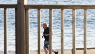Britain's Prime Minister Johnson runs along the beach in Carbis Bay, during the G7 summit in Cornwall, Britain June 12, 2021. Stefan Rousseau/PA Wire/Pool via REUTERS