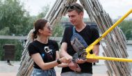 Alexandr Kudlay and Viktoria Pustovitova have the chain dismantled by a representative from a Ukrainian record book in Kyiv, Ukraine June 17, 2021. REUTERS/Gleb Garanich
