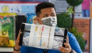Village official Paolo Tolentino holds the raffle jar during the weekly raffle draw of sacks of rice for residents vaccinated against the coronavirus disease (COVID-19), at the Barangay Sucat Covered Court, in Muntinlupa City, Metro Manila, Philippines, J