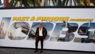  Cast member and producer Dwayne Johnson poses at the premiere for 