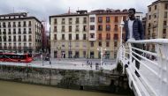 Mohamed Fadal Diouf, 26, from Senegal, stands on a pedestrian bridge over the river Nervion in Bilbao, from where he jumped to rescue a 72 year old man who had fallen in, June 24, 2021. REUTERS/Vincent West