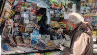 A man wears a protective face mask and gloves at the newsstand in Venice, Italy. (REUTERS/Manuel Silvestri/File Photo)