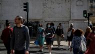 FILE PHOTO: People cross a street at a traffic light during the coronavirus disease (COVID-19) outbreak, in downtown Lisbon, Portugal October 9, 2020. REUTERS/Rafael Marchante/File Photo/File Photo
