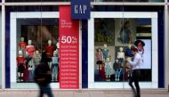 People walk past a Gap store on Oxford Street in London, Britain, July 1, 2021. REUTERS/John Sibley