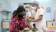 A healthcare worker holding a rose receives an AstraZeneca's COVISHIELD vaccine, during the coronavirus disease (COVID-19) vaccination campaign, at a medical centre in Mumbai, India, January 16, 2021. REUTERS/Francis Mascarenhas/File Photo
