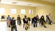 People wearing protective masks sit ahead of a vaccination, as South Africa rolls out the coronavirus disease (COVID-19) vaccines to the elderly at the Munsieville Care for the Aged Centre outside Johannesburg, South Africa May 17, 2021. REUTERS/Siphiwe S