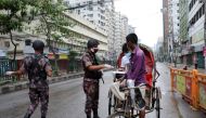Members of Border Guard Bangladesh (BGB) check commuters at a checkpost during a countrywide lockdown in Dhaka, Bangladesh, July 1, 2021. REUTERS/Mohammad Ponir Hossain