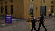 People walk past the queue area for a coronavirus disease (COVID-19) testing centre during a lockdown to curb the spread of a COVID-19 outbreak in Sydney, Australia, July 8, 2021. REUTERS/Loren Elliott
