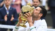Tennis - Wimbledon - All England Lawn Tennis and Croquet Club, London, Britain - July 11, 2021 Serbia's Novak Djokovic celebrates with the trophy after winning his final match against Italy's Matteo Berrettini REUTERS/Toby Melville
