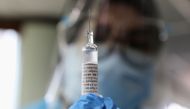 A medical worker holds a dose of Biokangtai's coronavirus disease (COVID-19) vaccine during a vaccination program at a factory, in Pulau Indah, Malaysia July 8, 2021. REUTERS/Lim Huey Teng/File Photo