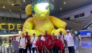 Qatari athletes and officials pose for a photograph at the Hamad International Airport
in Doha prior to their departure for Tokyo.