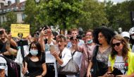 Protesters hold placards during a demonstration called by the 
