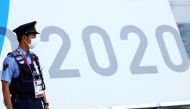 A police officer wearing a face mask stands guard during the Tokyo 2020 Olympic Games in Tokyo, Japan, July 24, 2021. REUTERS/Siphiwe Sibeko
