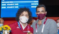 Qatar Olympic Committee (QOC) President Sheikh Joaan bin Hamad Al Thani, poses for a photograph with Fares Ibrahim after the Qatari weightlifter win the country's first ever Olympic gold medal.